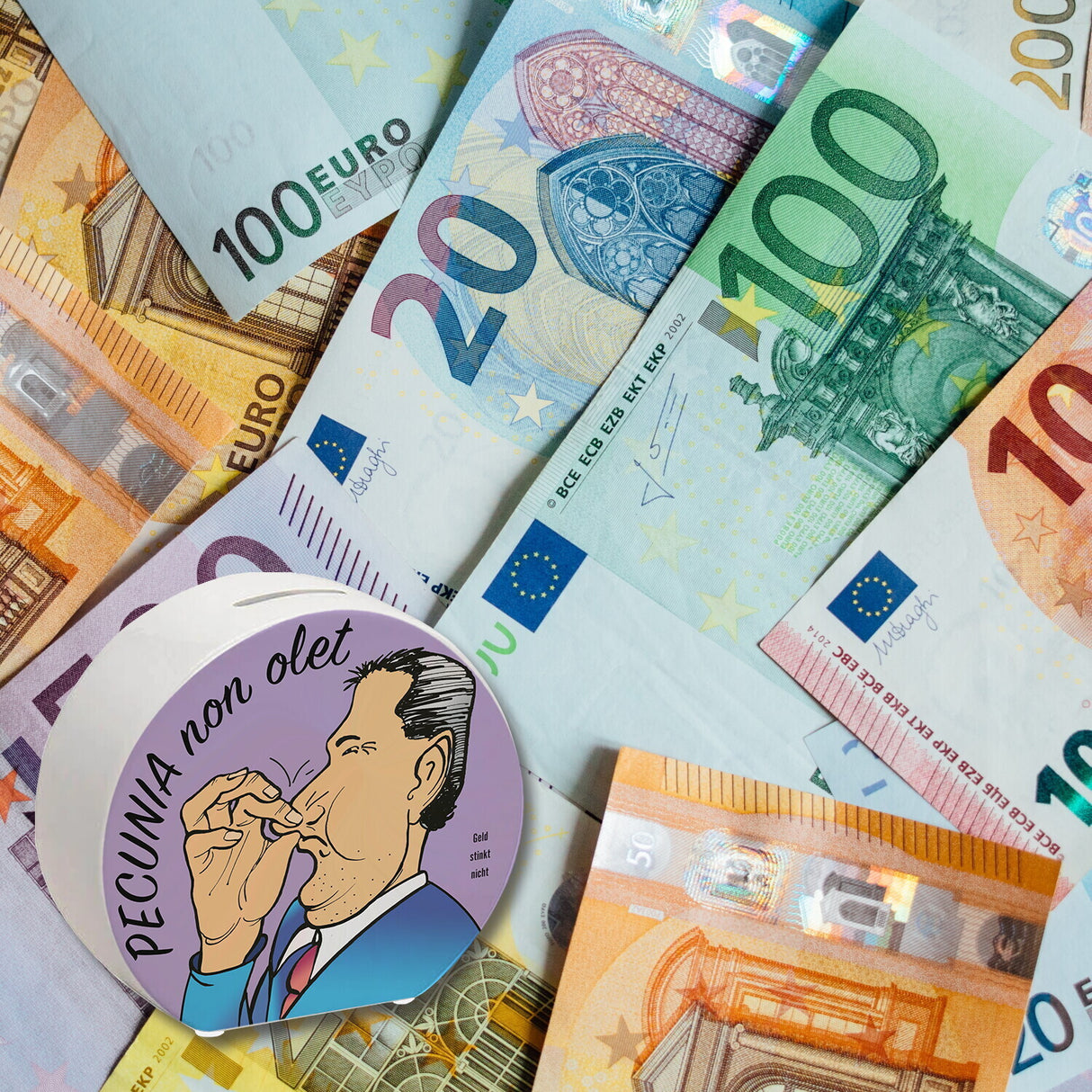 Pecunia non olet Spardose in Lila zum Thema Geld
