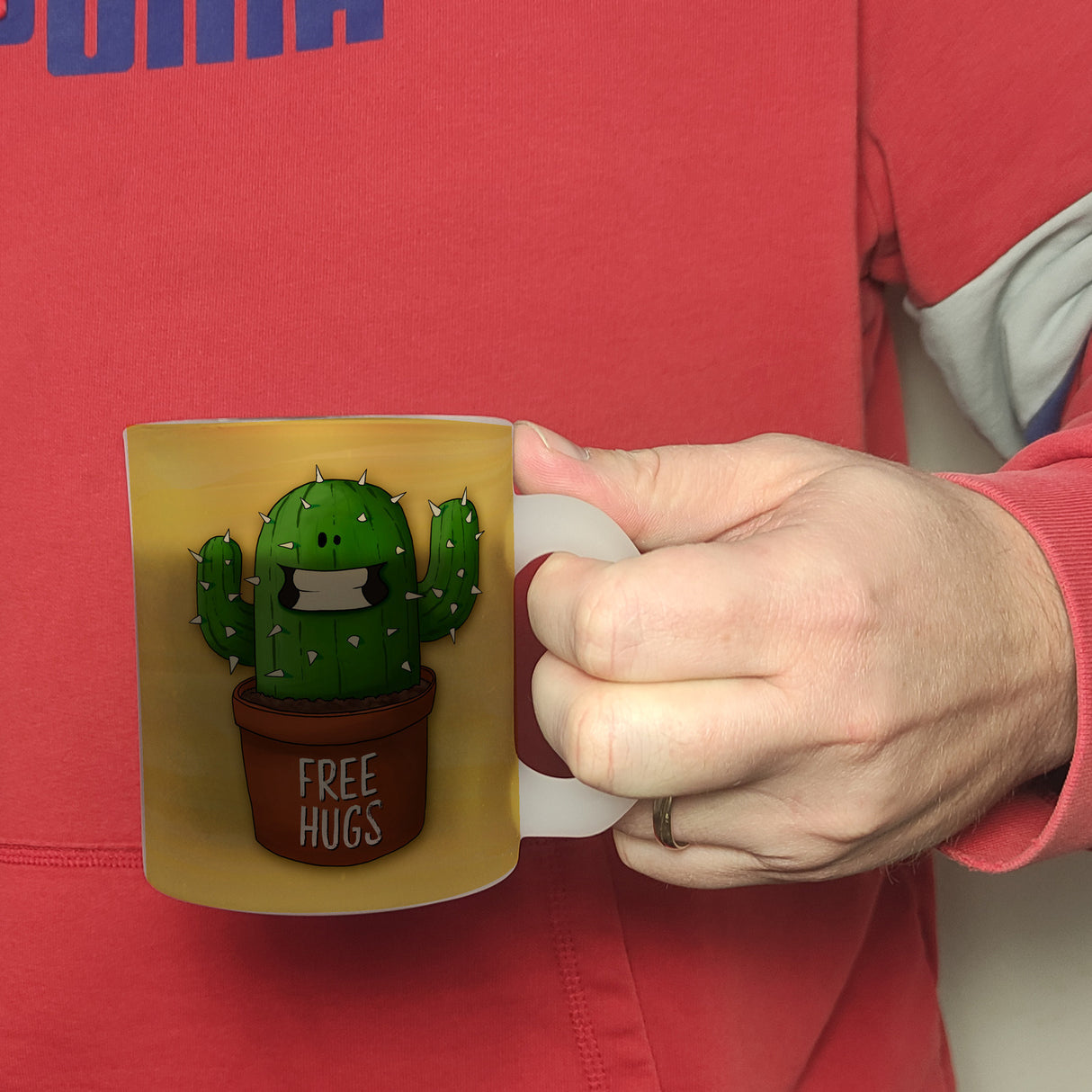 Kaffeebecher mit freundlicher Kaktus Motiv und Spruch: Free Hugs