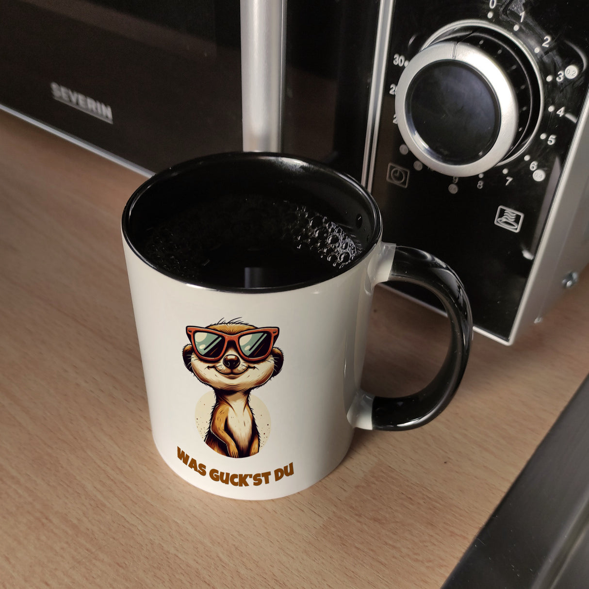 Erdmännchen Geschenke Kaffeebecher mit Spruch Was guckst du