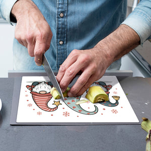 Weihnachtswichtel mit Geschenk Schneidebrett aus Glas Weihnachten