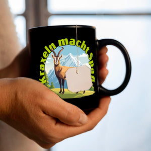 Steinbock Tasse in Schwarz mit Spruch: Kraxeln macht Spass