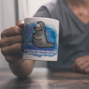 Kaffeebecher mit Seehund Motiv und Spruch: Ich will einen Seehund, der klatscht, ...